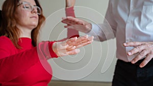 An elderly man hypnotizes a female patient. A woman in a session with a male hypnotherapist during a session. Therapist