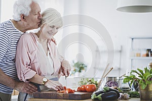 Elderly man kissing wife