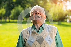 Elderly man laughing.