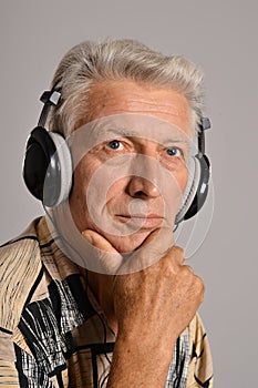 Elderly man listen to music in headphones