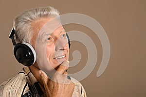 Elderly man listen to music in headphones