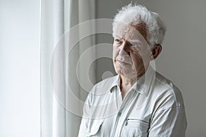 Elderly man looking away and thinking