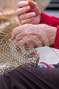 Elderly man makes baskets for use in the fishing industry in the traditional way, in Gallipoli, Puglia, Italy.