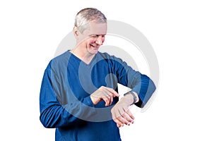 An elderly man measures the pulse of a fitness bracelet. Isolated on a white background