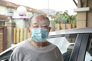 Elderly man with medical face mask at home