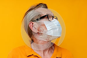 elderly man medical mask on the face protection close-up isolated background