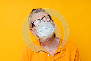 elderly man medical mask on the face protection close-up isolated background