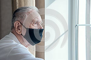 Elderly man in a medical mask. He has the flu. Protecting people around you from the virus. concept of a pandemic. Close up