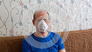 an elderly man in a medical mask is in quarantine and self-isolation, protecting the elderly from viruses and diseases