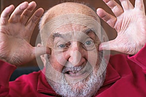 elderly man mocking and ridiculing
