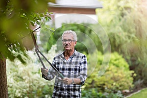 Elderly man mowing the lawn