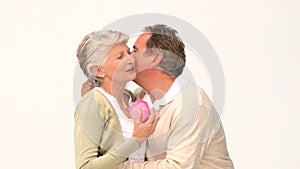 Elderly man offering a necklace to his wife