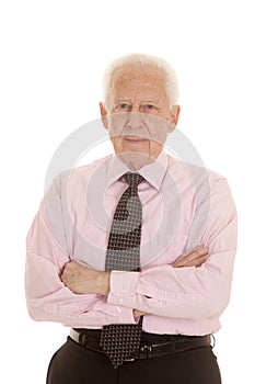 Elderly man pink shirt arms folded