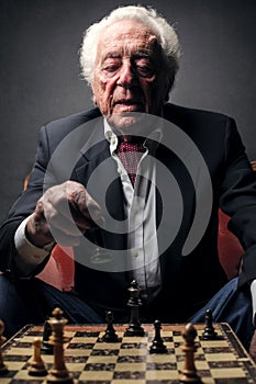 Elderly man playing chess