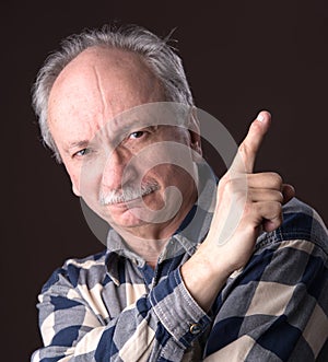 Elderly man pointing up