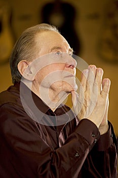 Elderly man praying in church