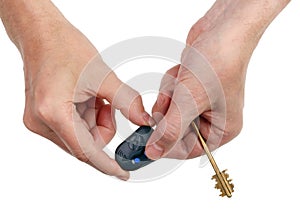 An elderly man presses a button on the remote control of an auto