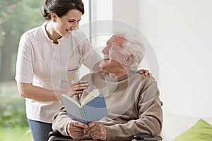 Elderly man reading book