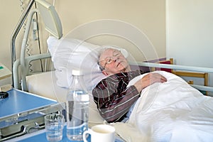 Elderly man recuperating in a hospital photo