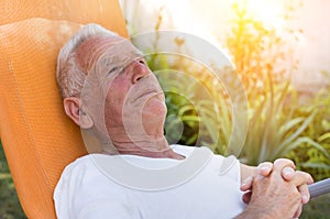 Elderly man resting in garden