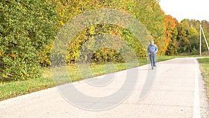 An elderly man rides a scooter in a Park for the first time in his life. Active lifestyle for the elderly.