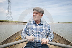 Elderly Man Rowing Boat