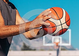 Elderly man& x27;s hands ready to pass sport ball at sunny summer day