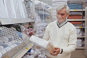 Elderly man shopping at home goods store