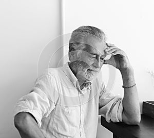 Elderly man is sitting thoughtfully