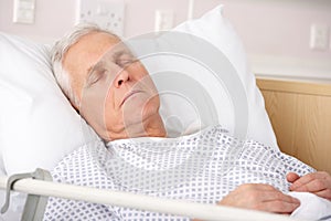 Elderly man sleeping in hospital bed