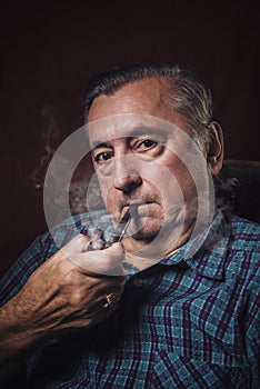Elderly man smoking a pipe
