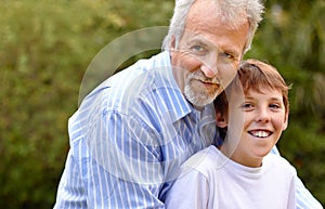 Elderly, man or son with hug in nature outdoor at a park, backyard or environment for bonding and care. Family, father