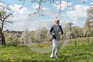 Elderly man in sportswear on a walk . Healthy and active lifestyle of retirees. Wellness walking to speed up metabolism