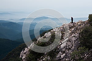 Elderly man standing on the edge of the cliff