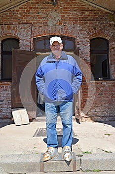 An elderly man stands in foot knight`s armor. Shaaken Castle, XIII century. Kaliningrad region