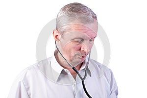 Elderly man with a stethoscope in his ears. Isolated on a white background