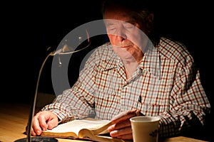 Elderly man studying the Bible