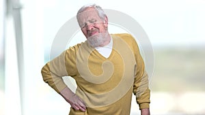 Elderly man is suffering from back pain.