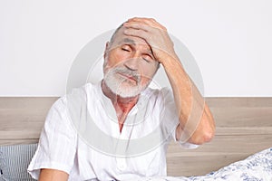 Elderly man suffering from headache