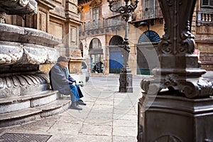 Elderly man suffering from loneliness sitting on the bench, Palermo