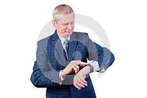 An elderly man in a suit measures the pulse of a fitness bracelet. Isolated on a white background