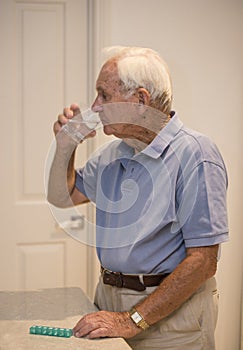 Elderly Man Taking Medication.