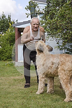 Elderly man talking with a dog