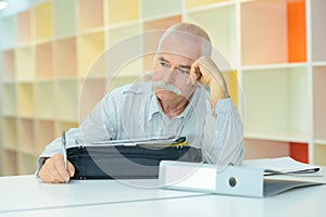 Elderly man with thoughful face indoors