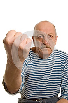 The elderly man threatens with a fist