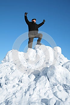 Elderly man on top of snow hill