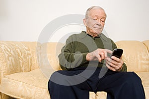 Elderly man using remote control