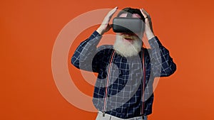 Elderly man using virtual reality VR app headset helmet to play simulation 3d 360 video game drawing