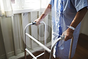 An elderly man using a walker