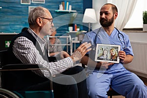 Elderly man on video call with family with help from nurse